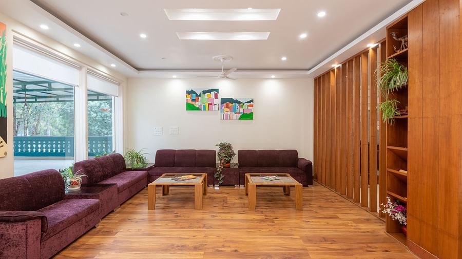 A spacious and inviting lobby at DLS Tehri Club Resort with comfortable seating and modern decor.